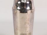 silver plated cocktail shaker with a black lid on a white background