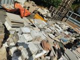a pile of junk on the ground next to a building