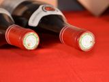 two bottles of wine sitting on a red table