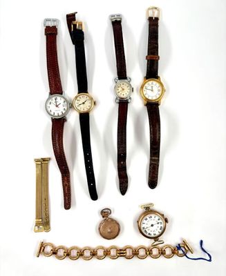 a lot of watches that are laying out on the table