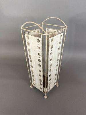 an image of a white metal planter with flowers on it
