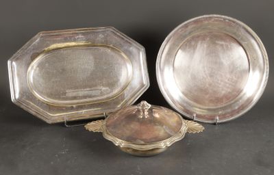 two silverplated dishes and a silver plate on a black surface