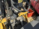 a forklift that is parked next to a red truck