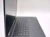 a black laptop with a silver keyboard on a white surface
