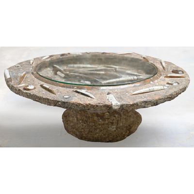 a glass bowl on a stone pedestal on a white background