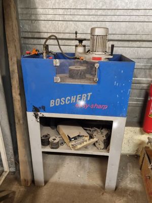 a blue machine that is sitting in a garage