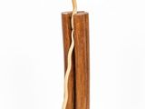a tall wooden candle with a crack in the middle