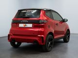 the rear end of a red car parked in a room