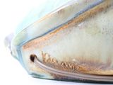 a close up of a vase with a handle on it