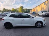 a white car parked in a parking lot next to a building