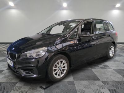 the bmw tourer is parked on a checkered tile floor