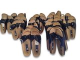 several pairs of sandals are lined up on a white surface