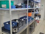 a room with many shelves and bins in it