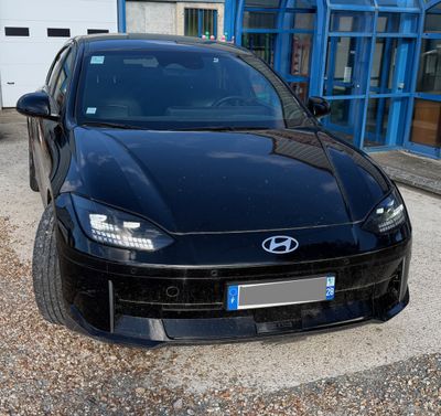 a black sports car parked in front of a building