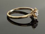 a close up of a diamond ring on a black surface
