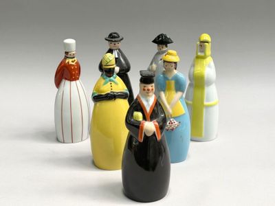 five figurines of people in different colors and sizes