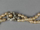 an image of a necklace with pearls and a diamond clasp