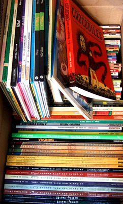 a box full of books that are stacked on top of each other