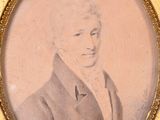 an old picture of a man in a suit and tie in a gold frame