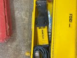 a yellow box with tools in it sitting on the floor