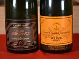 two bottles of champagne sitting next to each other on a table