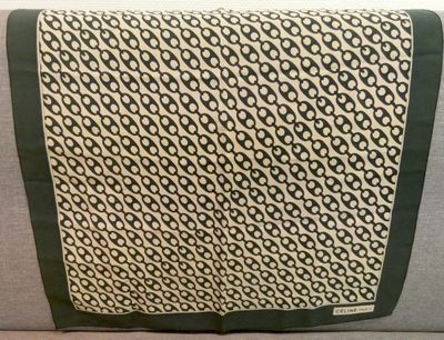 a close up of a black and white scarf on a couch