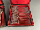 a lot of spoons in a case on the table
