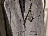 a suit on a hanger next to a pair of pants