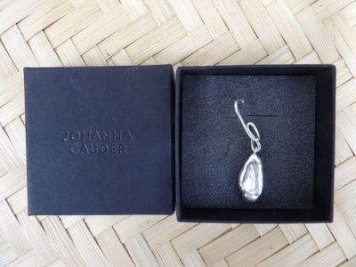 an image of a pair of earrings in a box on a table