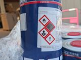 three cans of paint sitting on a table in a warehouse