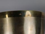 a metal bowl that is sitting on a table