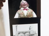 a man that is holding a picture of a clown