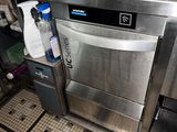 un comptoir en acier inoxydable surmonté d'un distributeur de boissons
