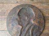 a wooden plaque with a picture of a man on it