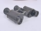 two binoculars that are sitting on a table next to each other