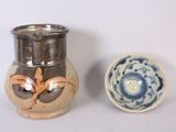 two vases sitting next to each other on a table