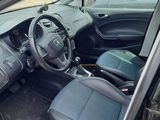 the interior of a car with the door open and the driver ' s seat down