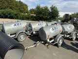 many different types of tanks lined up in a parking lot