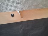 a piece of cardboard with a hole in it on the floor