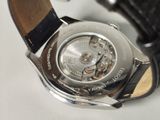 a close up of a watch on a white surface