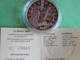 a picture of a piece of paper with a coin on it