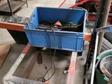 a blue container sitting on top of a table in a garage