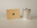 a flask that is sitting next to a box on a table