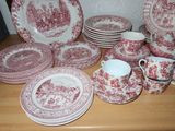 a lot of red and white plates and cups on the table