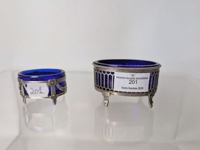pair of silver and blue glass dishes on display in a glass case
