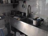 a kitchen with a sink and a lot of dishes on the counter
