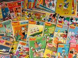 a pile of mickey mouse comic books on the floor