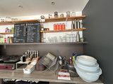 a counter with a lot of dishes and cups on it