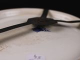 a white plate with a clock on it with a sticker on it