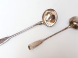 two spoons that are sitting on a table